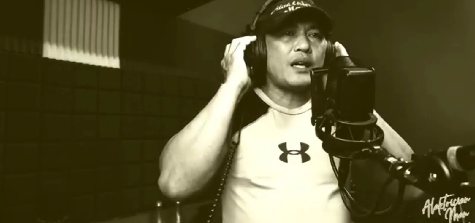 Performer recording at a studio microphone.